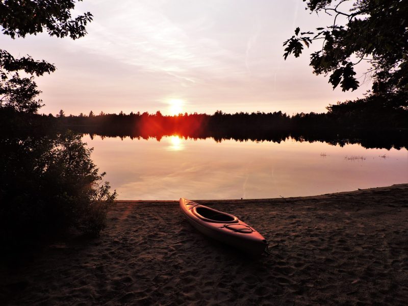 Kayak on beach during sunset at Andrus Lake Camp