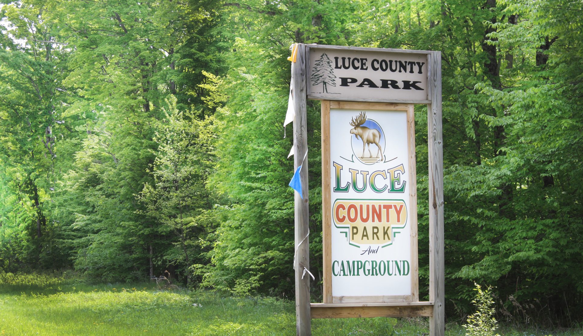 Luce County Park and Campground wooden sign in front of woods